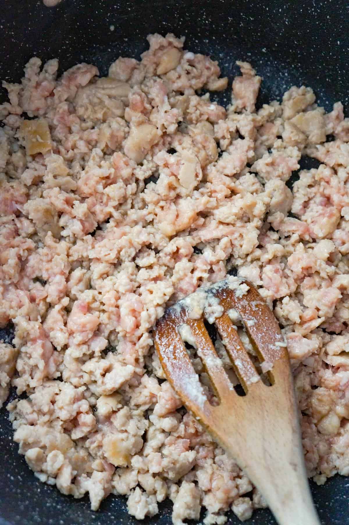crumbled sausage meat cooking in a saute pan
