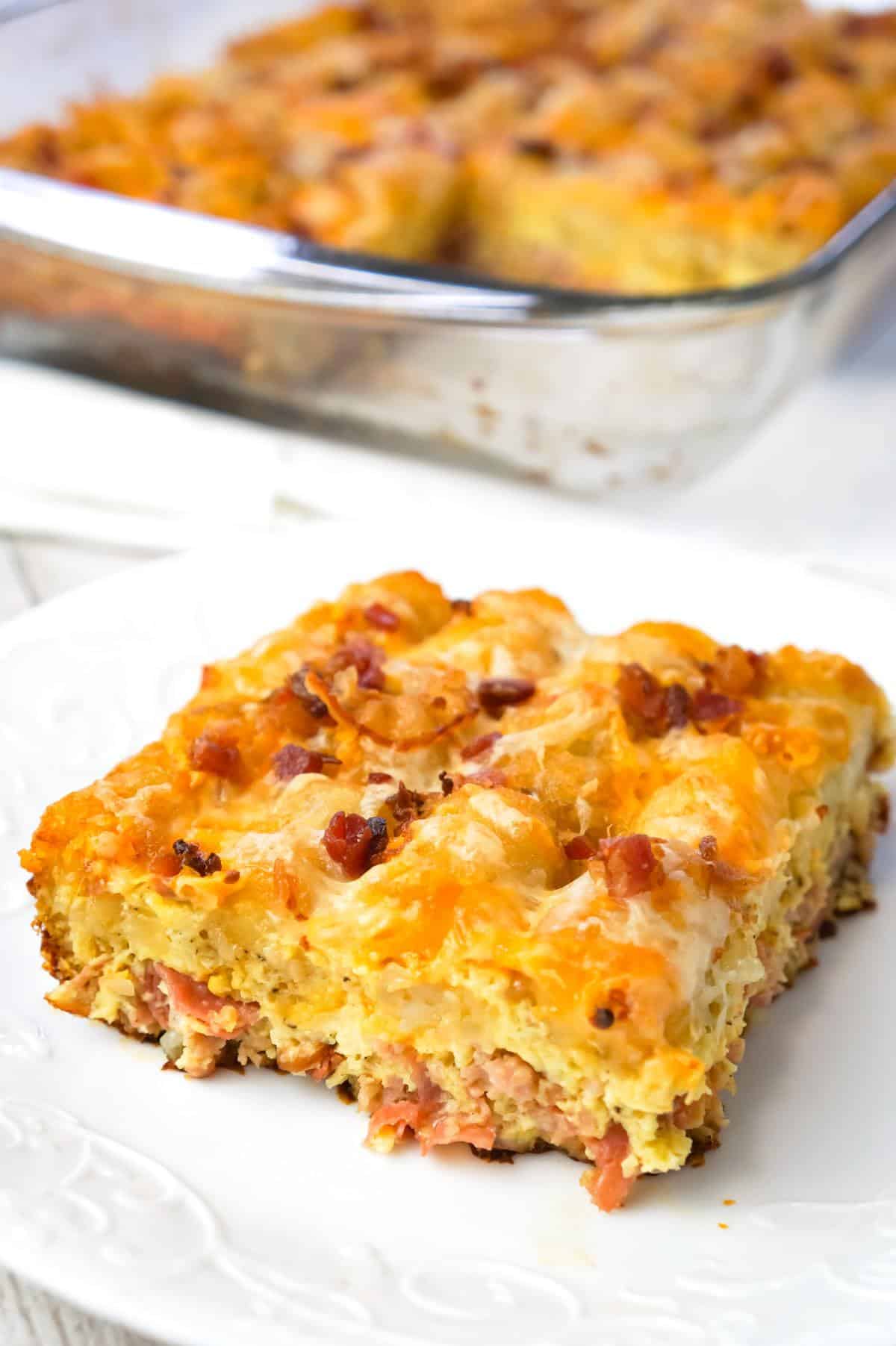 Tater Tot Breakfast Casserole is a hearty casserole recipe loaded with pork sausage meat, diced onion, chopped ham, crumbled bacon, eggs, shredded cheese and topped with tater tots.