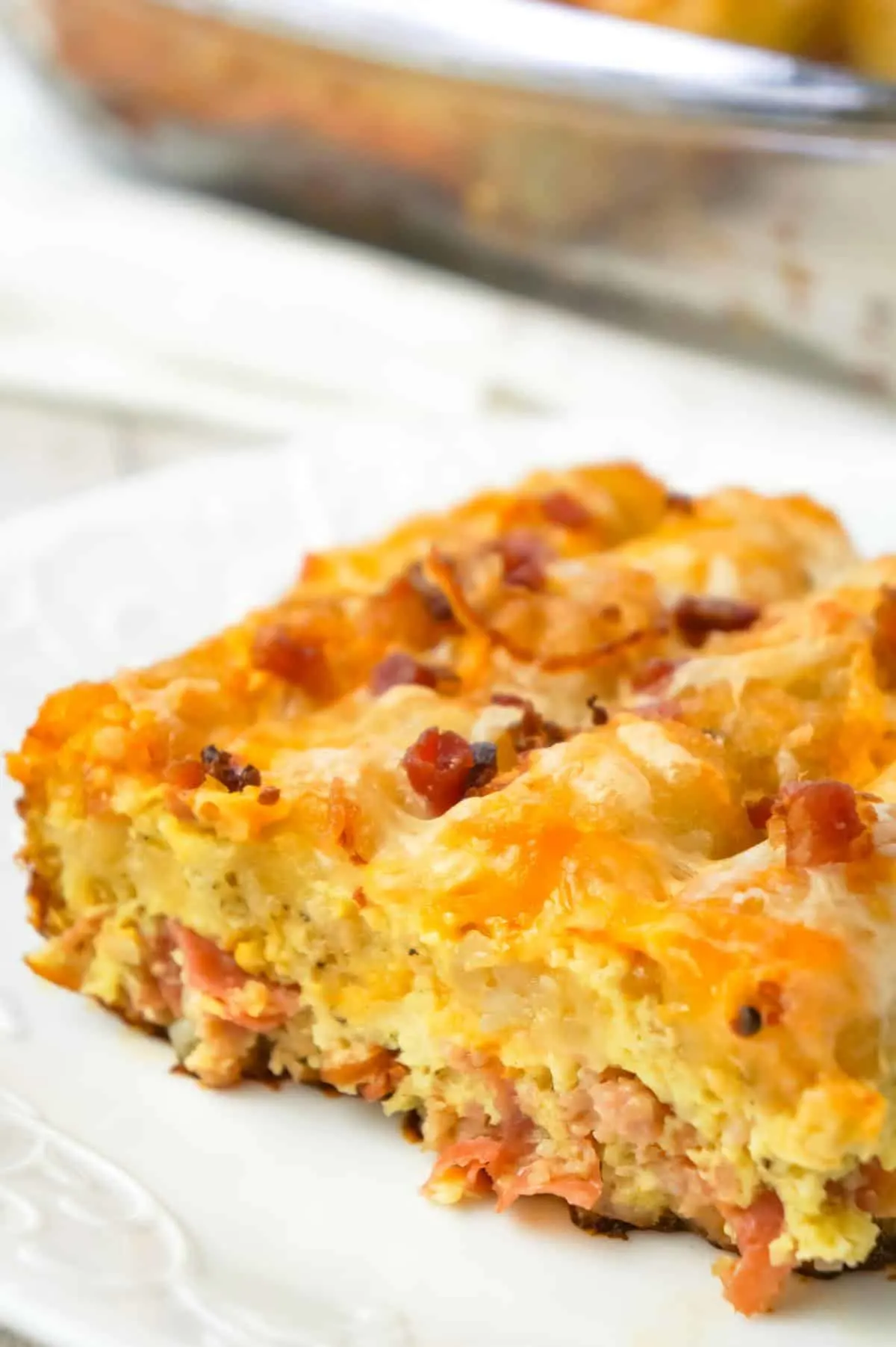 Tater Tot Breakfast Casserole is a hearty casserole recipe loaded with pork sausage meat, diced onion, chopped ham, crumbled bacon, eggs, shredded cheese and topped with tater tots.