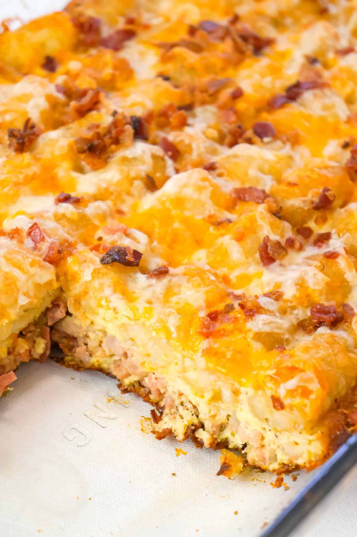 Tater Tot Breakfast Casserole is a hearty casserole recipe loaded with pork sausage meat, diced onion, chopped ham, crumbled bacon, eggs, shredded cheese and topped with tater tots.