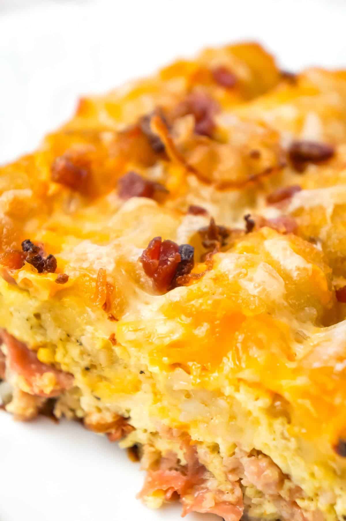 Tater Tot Breakfast Casserole is a hearty casserole recipe loaded with pork sausage meat, diced onion, chopped ham, crumbled bacon, eggs, shredded cheese and topped with tater tots.