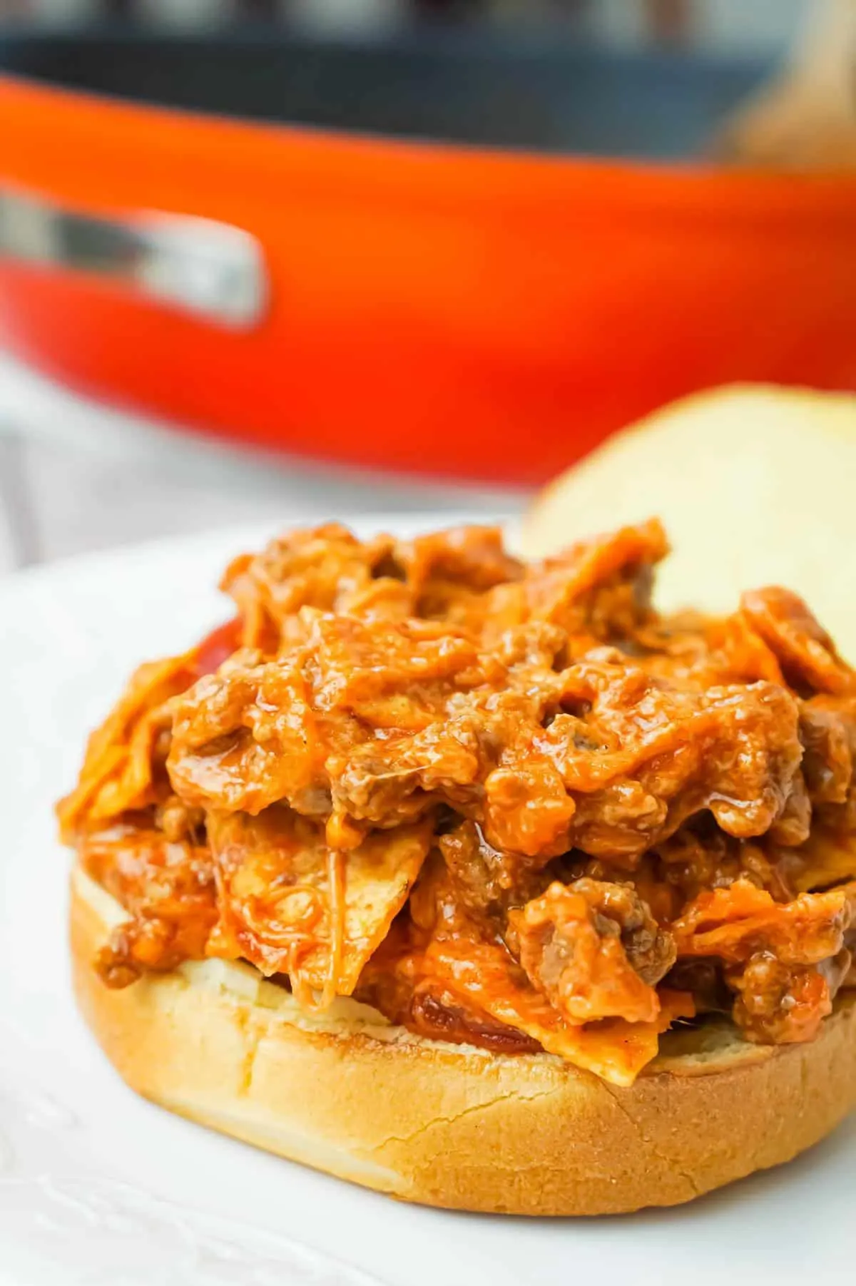 Beef Nacho Sloppy Joes is an easy ground beef dinner recipe loaded with taco seasoning, salsa, chili sauce, crumbled nacho chips and shredded cheese.