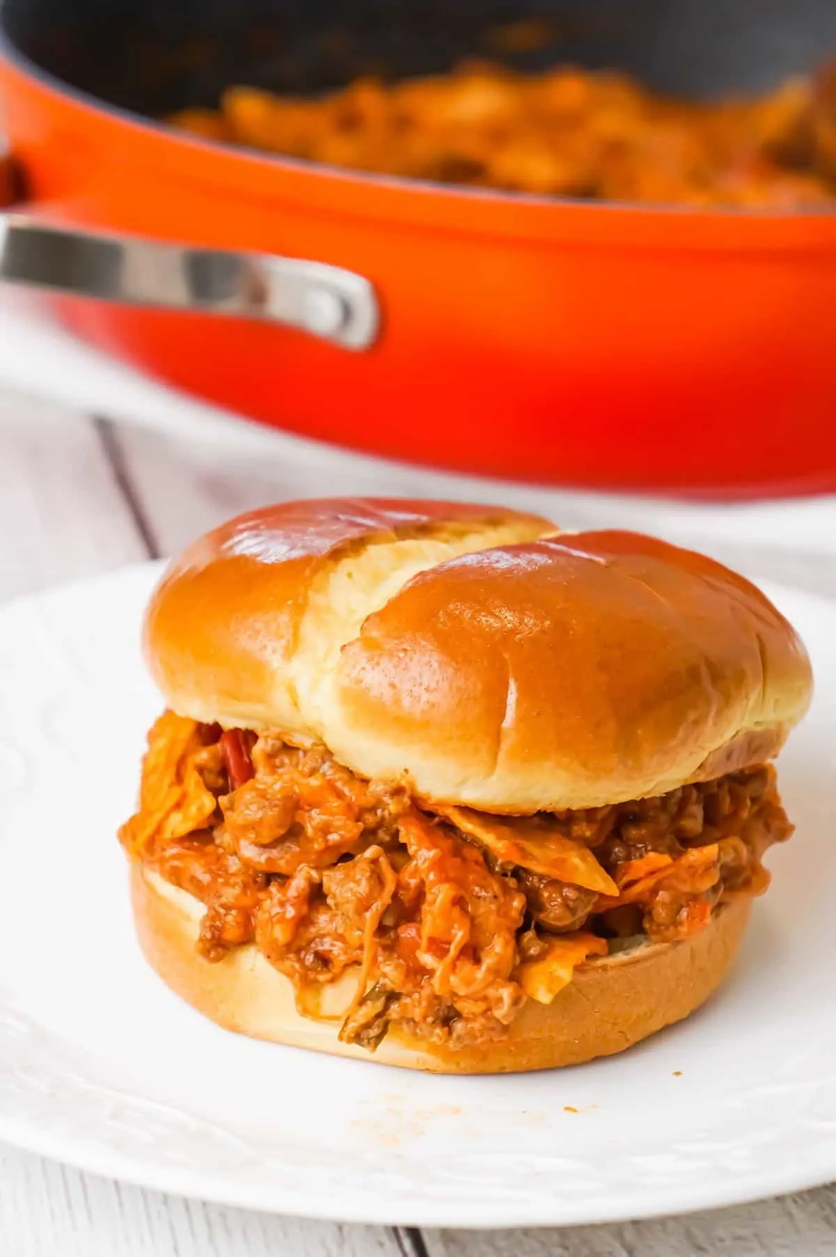 Beef Nacho Sloppy Joes is an easy ground beef dinner recipe loaded with taco seasoning, salsa, chili sauce, crumbled nacho chips and shredded cheese.