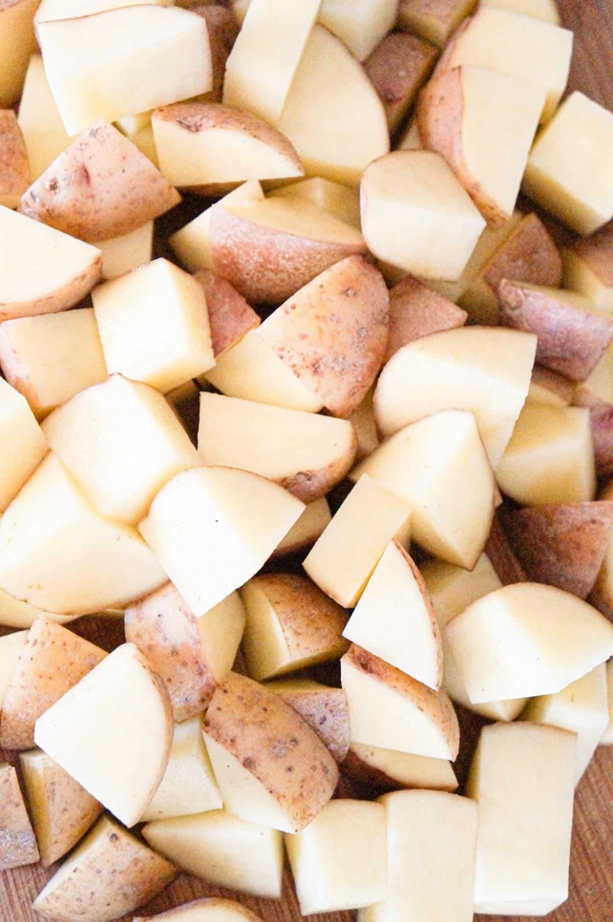 diced Yukon gold potatoes on a cutting board