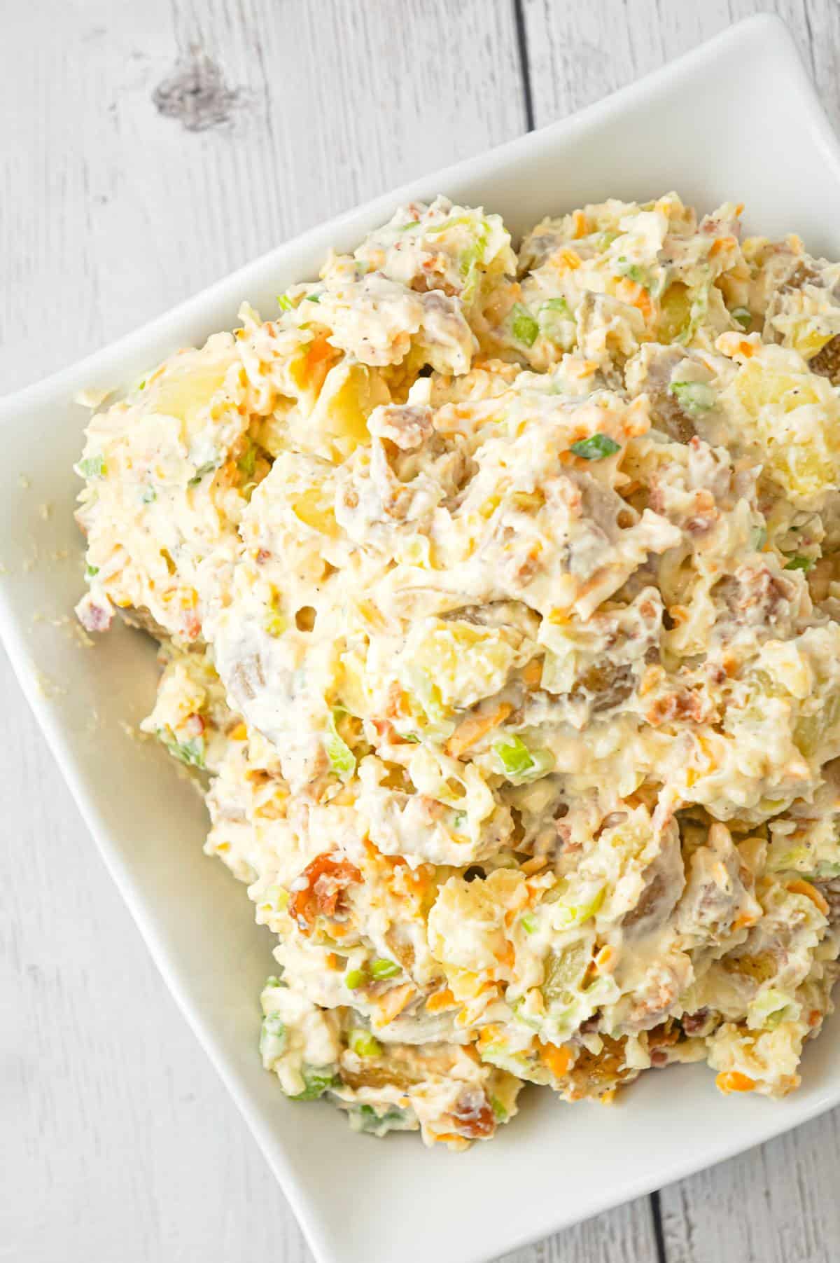 Cheddar Bacon Ranch Potato Salad is a creamy cold side dish recipe made with Yukon gold potatoes and loaded with crumbled bacon, cheddar cheese, chopped green onions, mayo and ranch dressing.