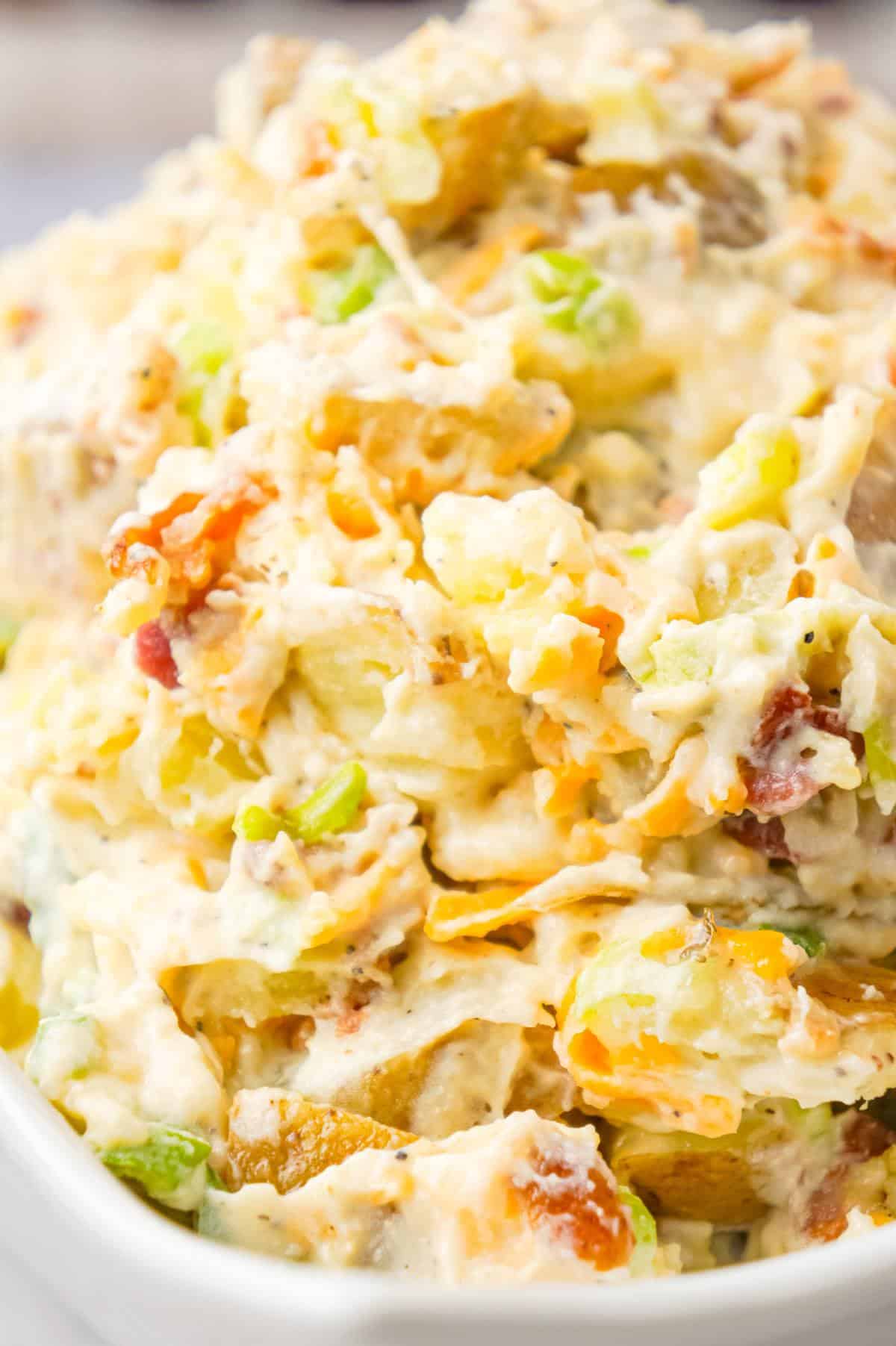 Cheddar Bacon Ranch Potato Salad is a creamy cold side dish recipe made with Yukon gold potatoes and loaded with crumbled bacon, cheddar cheese, chopped green onions, mayo and ranch dressing.