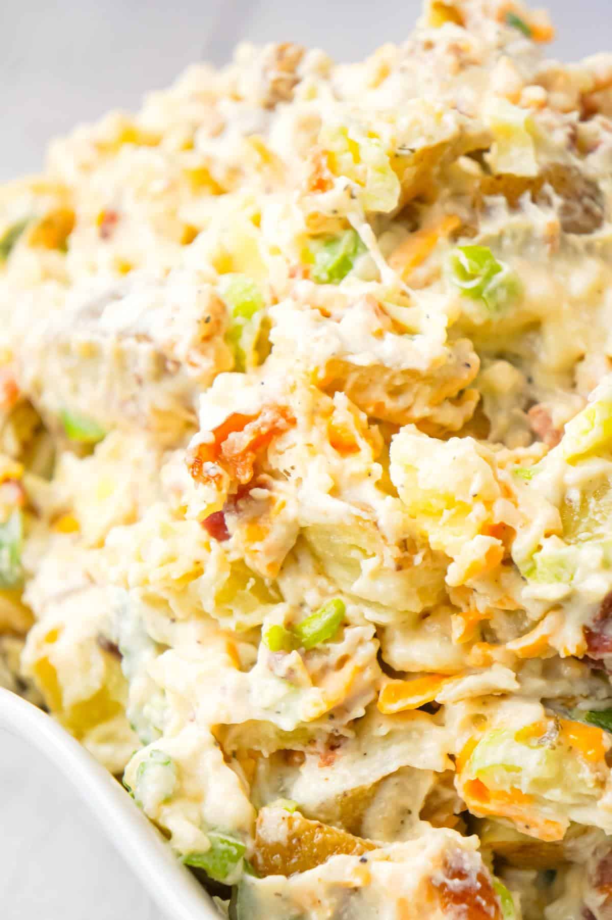 Cheddar Bacon Ranch Potato Salad is a creamy cold side dish recipe made with Yukon gold potatoes and loaded with crumbled bacon, cheddar cheese, chopped green onions, mayo and ranch dressing.