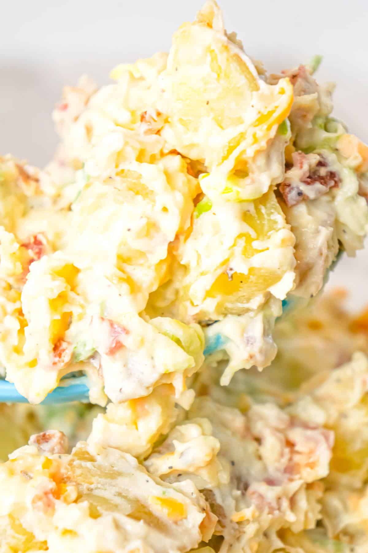 Cheddar Bacon Ranch Potato Salad is a creamy cold side dish recipe made with Yukon gold potatoes and loaded with crumbled bacon, cheddar cheese, chopped green onions, mayo and ranch dressing.
