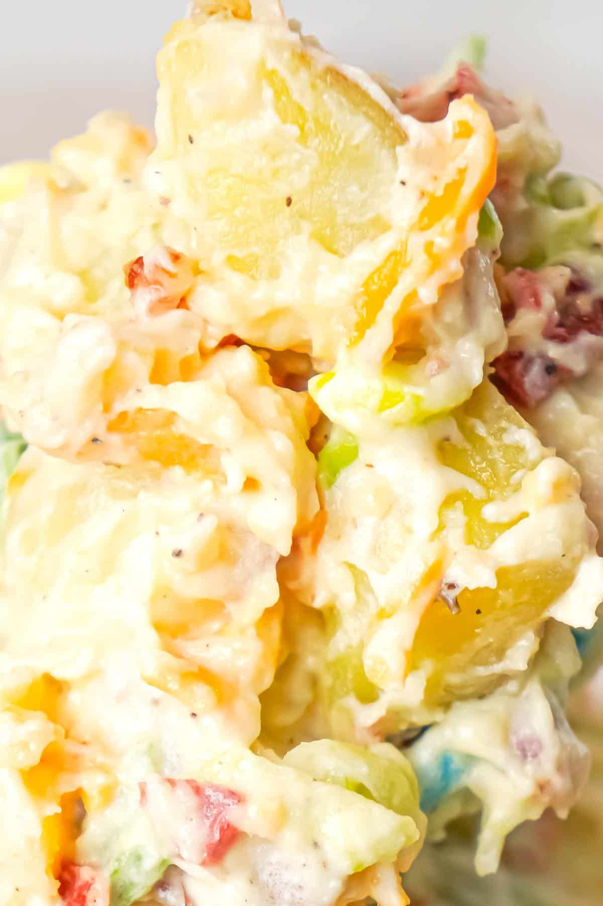 Cheddar Bacon Ranch Potato Salad is a creamy cold side dish recipe made with Yukon gold potatoes and loaded with crumbled bacon, cheddar cheese, chopped green onions, mayo and ranch dressing.