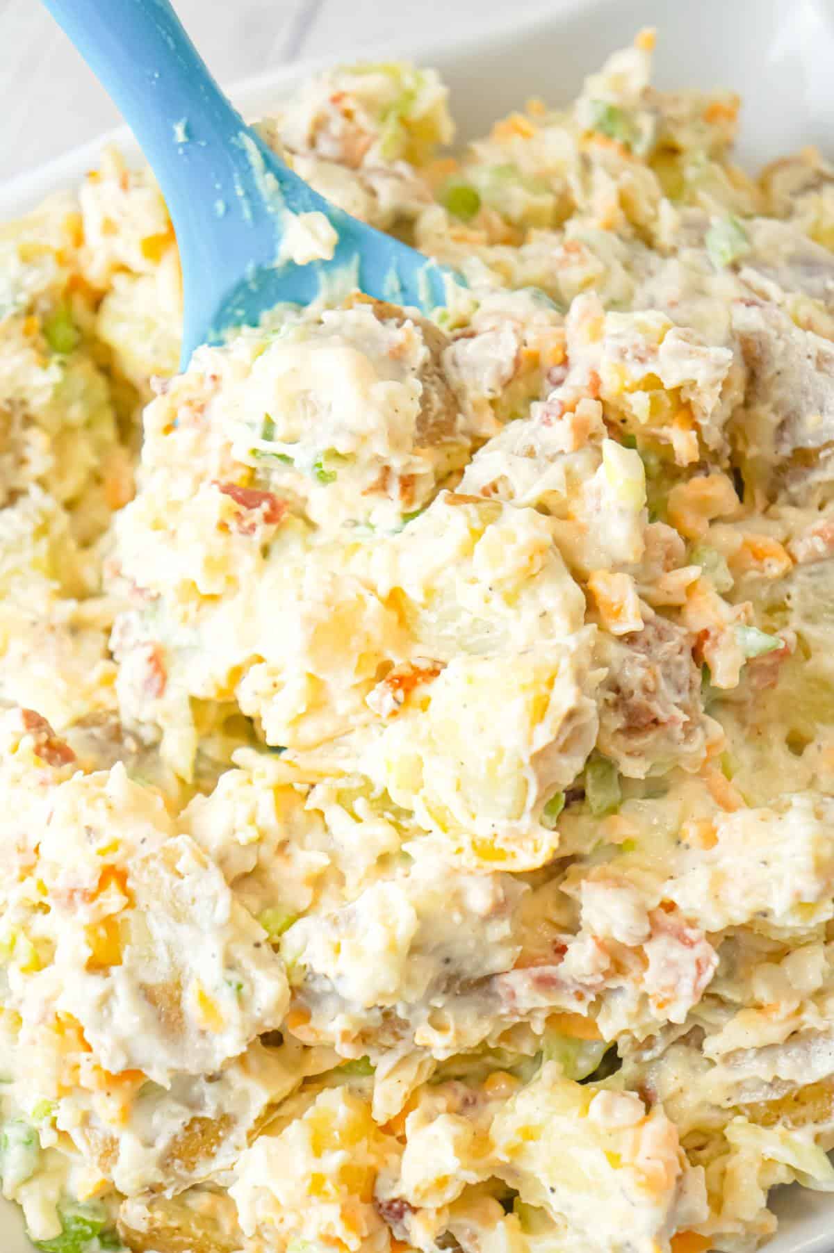 Cheddar Bacon Ranch Potato Salad is a creamy cold side dish recipe made with Yukon gold potatoes and loaded with crumbled bacon, cheddar cheese, chopped green onions, mayo and ranch dressing.