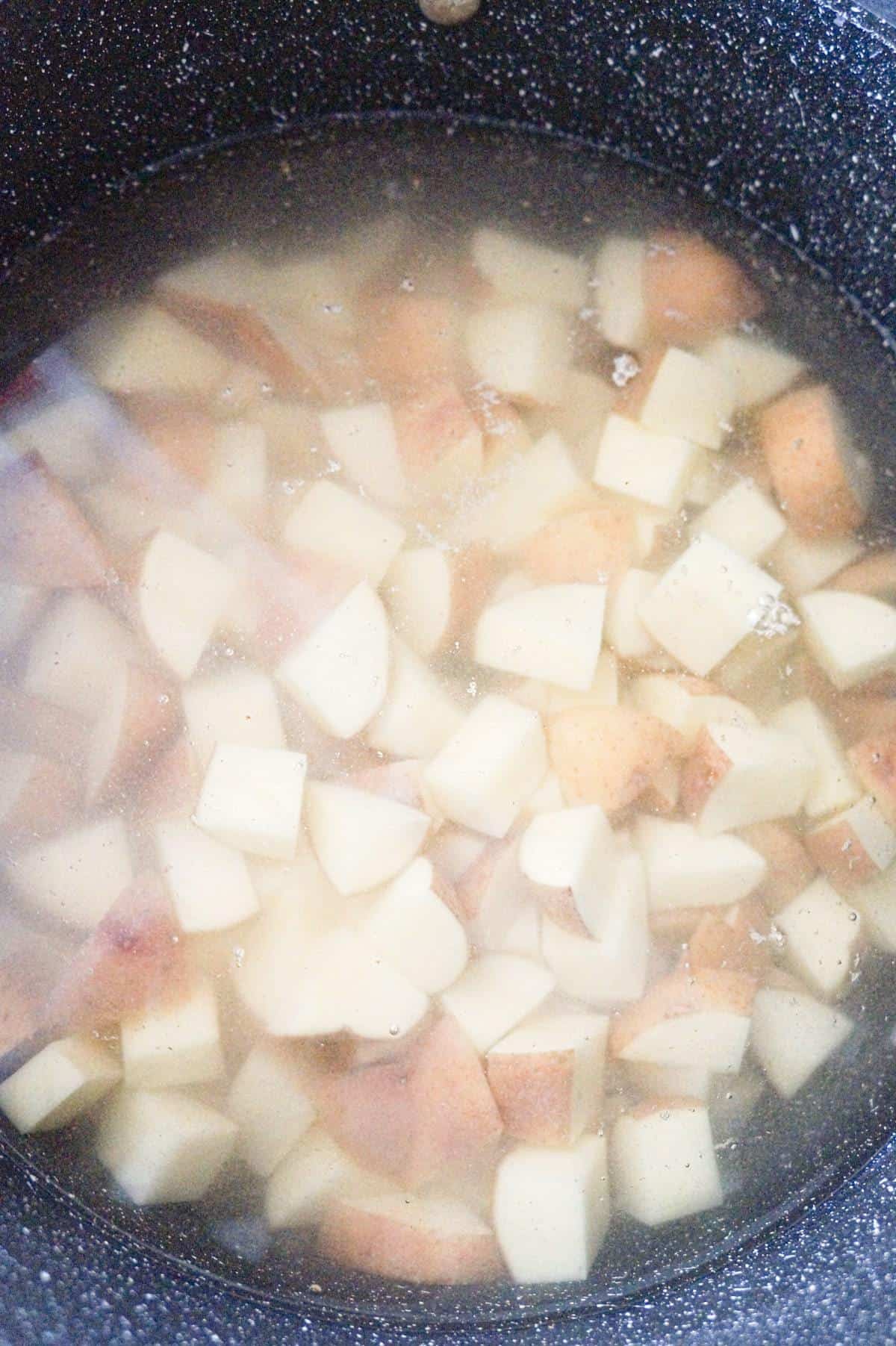 diced potatoes in pot of water