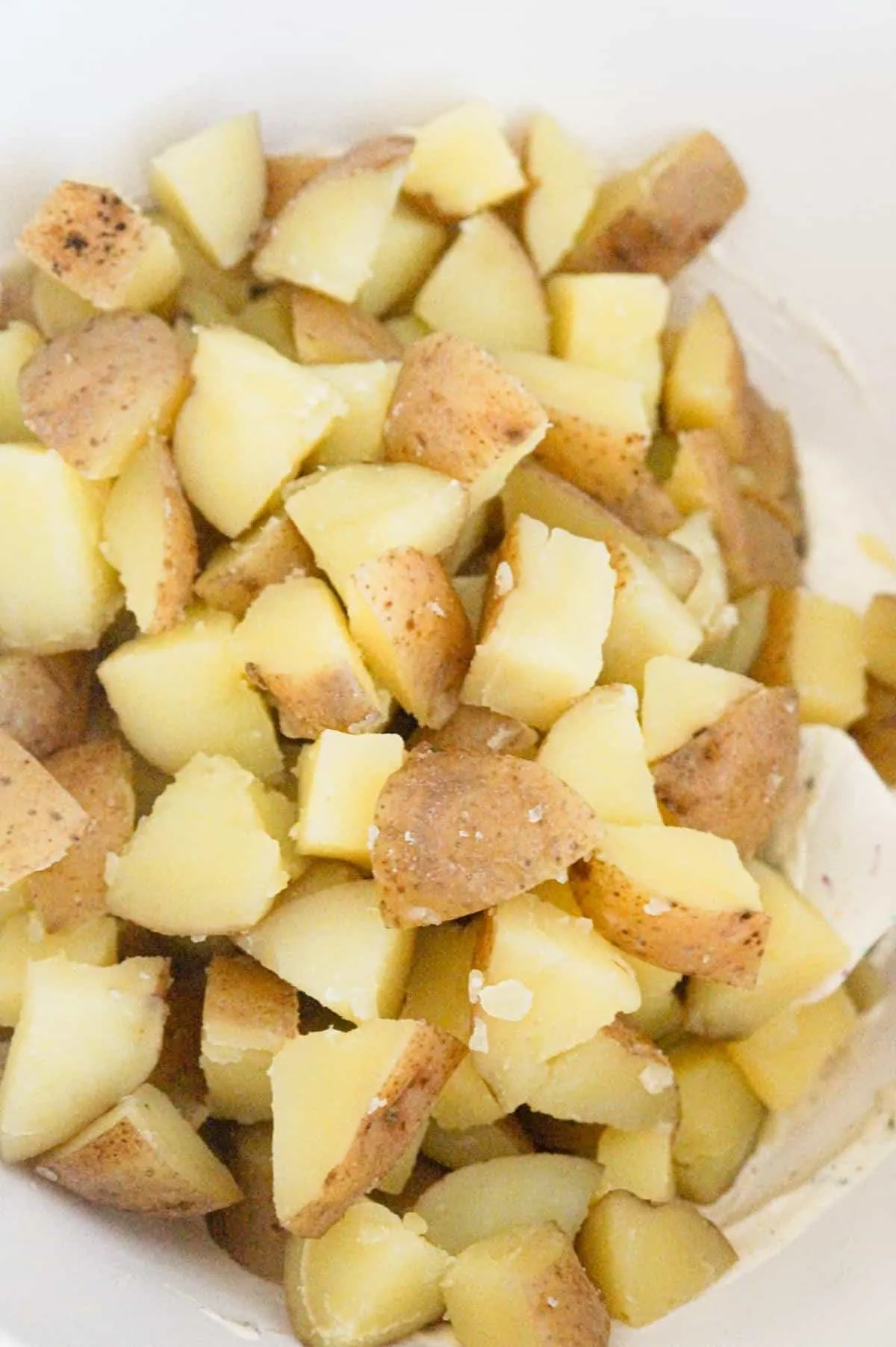 cooked diced potatoes in a mixing bowl