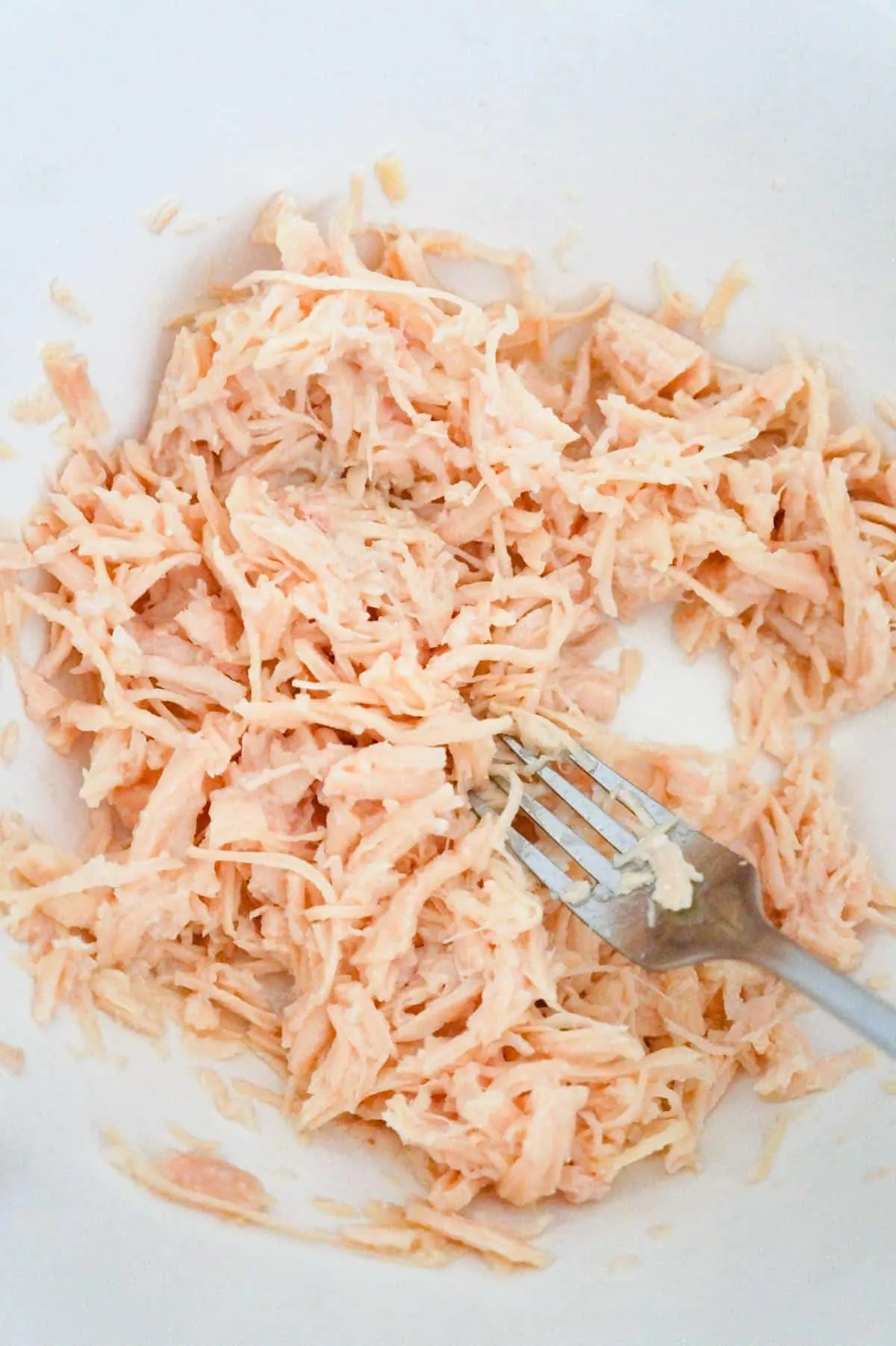 shredded canned chicken in a mixing bowl
