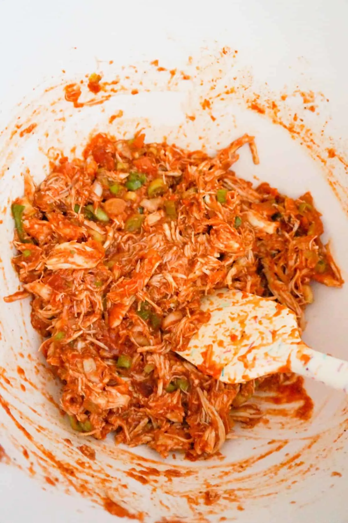 shredded chicken and salsa mixture in a mixing bowl