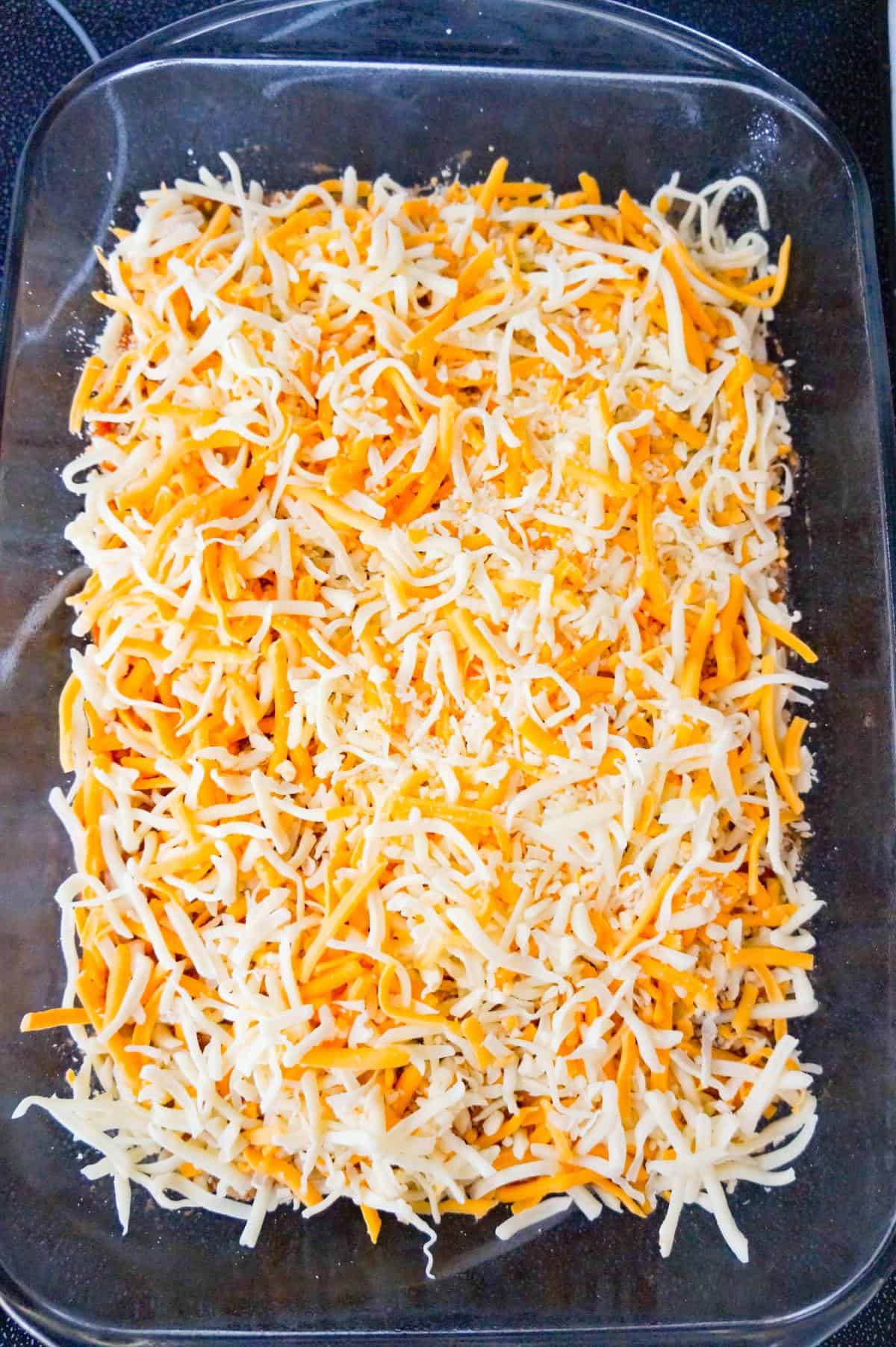 shredded cheese on top of chicken and salsa mixture