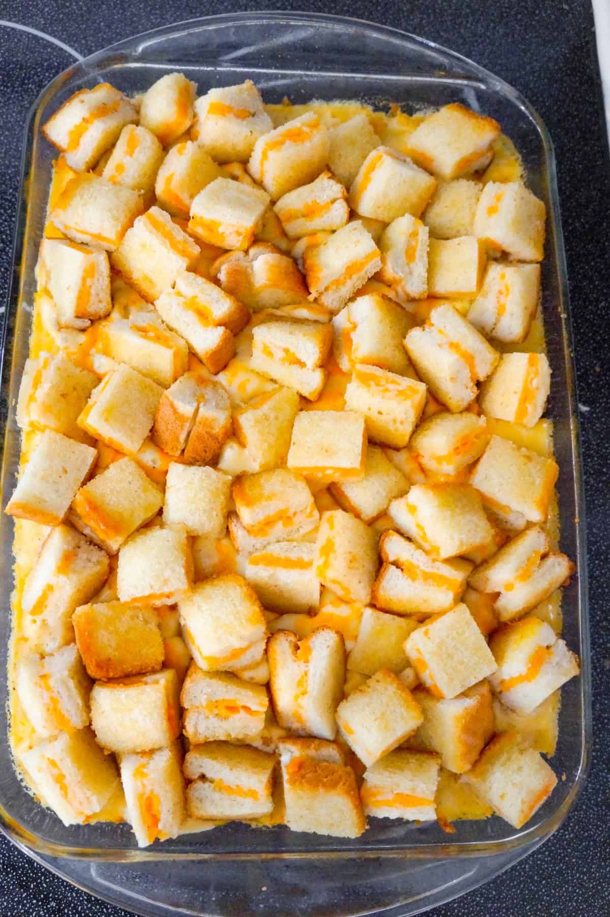 Grilled Cheese Mac and Cheese is a delicious baked macaroni and cheese recipe topped with bite sized pieces of grilled cheese sandwiches.