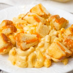 Grilled Cheese Mac and Cheese is a delicious baked macaroni and cheese recipe topped with bite sized pieces of grilled cheese sandwiches.