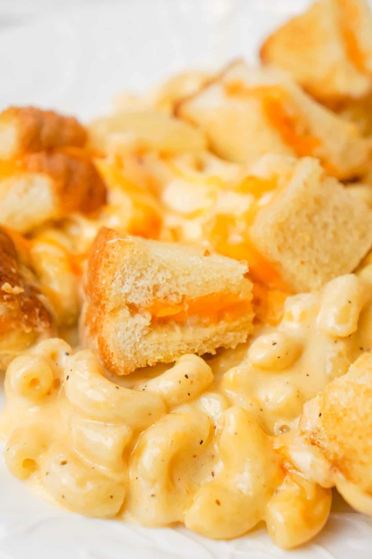 Grilled Cheese Mac and Cheese is a delicious baked macaroni and cheese recipe topped with bite sized pieces of grilled cheese sandwiches.