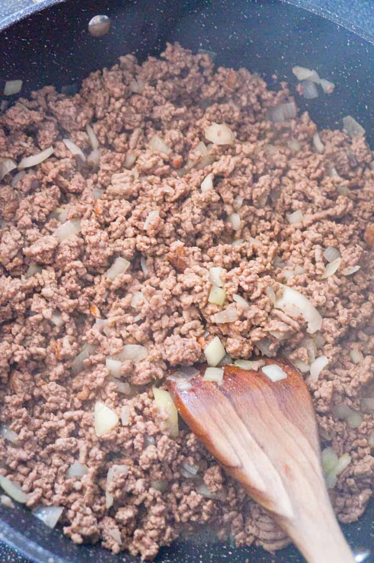 cooked ground beef and diced onions in a large saute pan