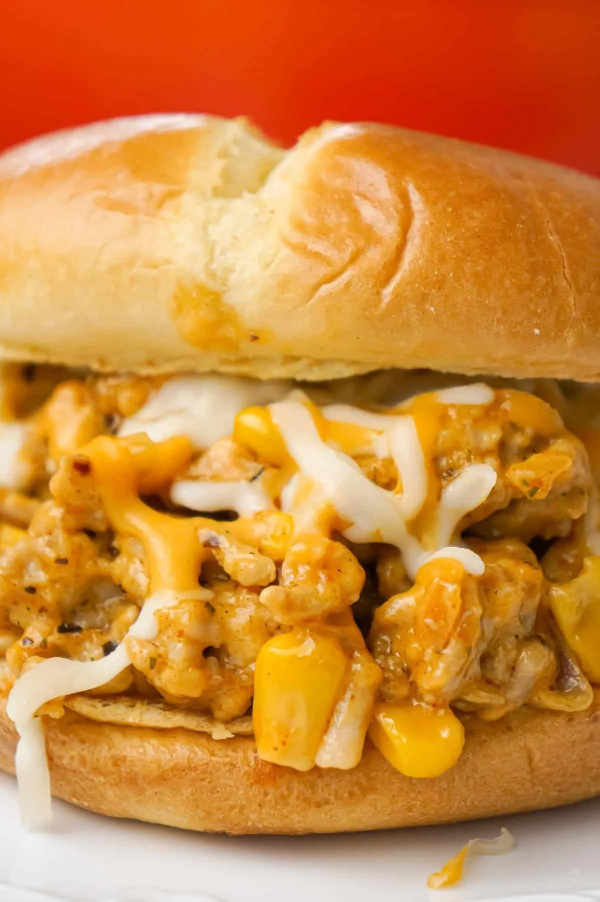 Cajun Chicken Sloppy Joes are an easy dinner recipe using ground chicken and loaded with corn, red onions, cream of chicken soup, Cajun seasoning and shredded cheese.