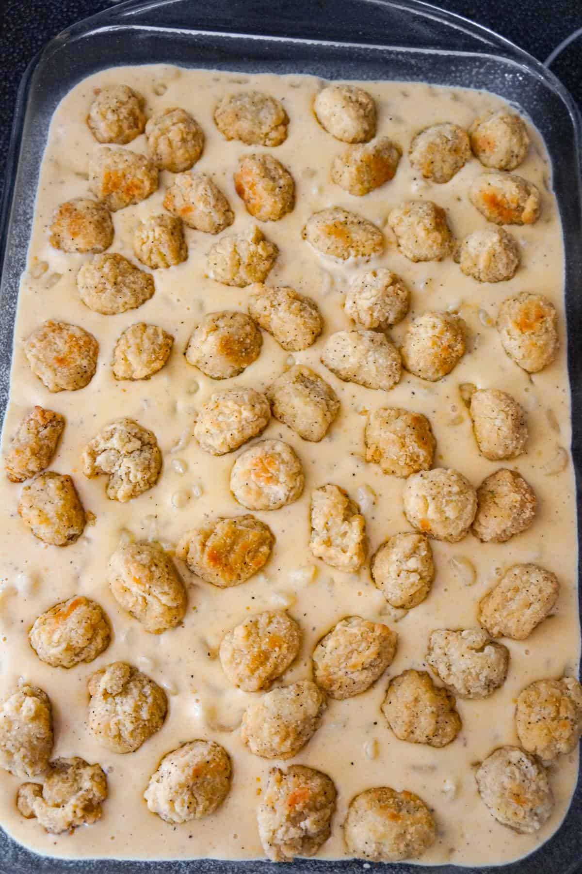 popcorn chicken on top of mac and cheese in a baking dish