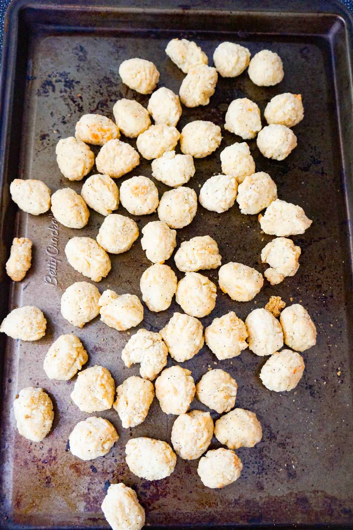 cooked popcorn chicken on a baking sheet