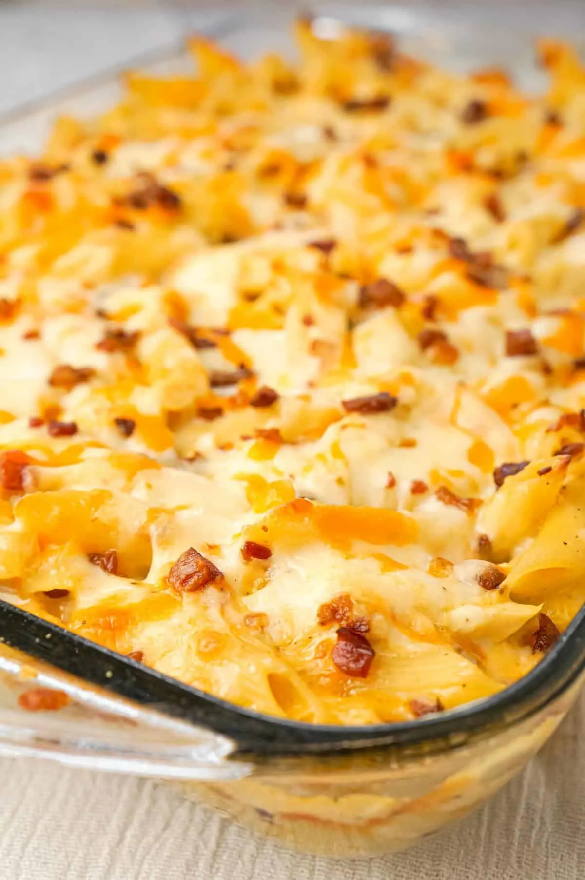 Cheddar Bacon Ranch Chicken Pasta is a delicious baked pasta recipe loaded with crumbled bacon, shredded chicken and cheddar cheese all in a creamy sauce made with cheddar cheese soup, cream of bacon soup and ranch dip mix.