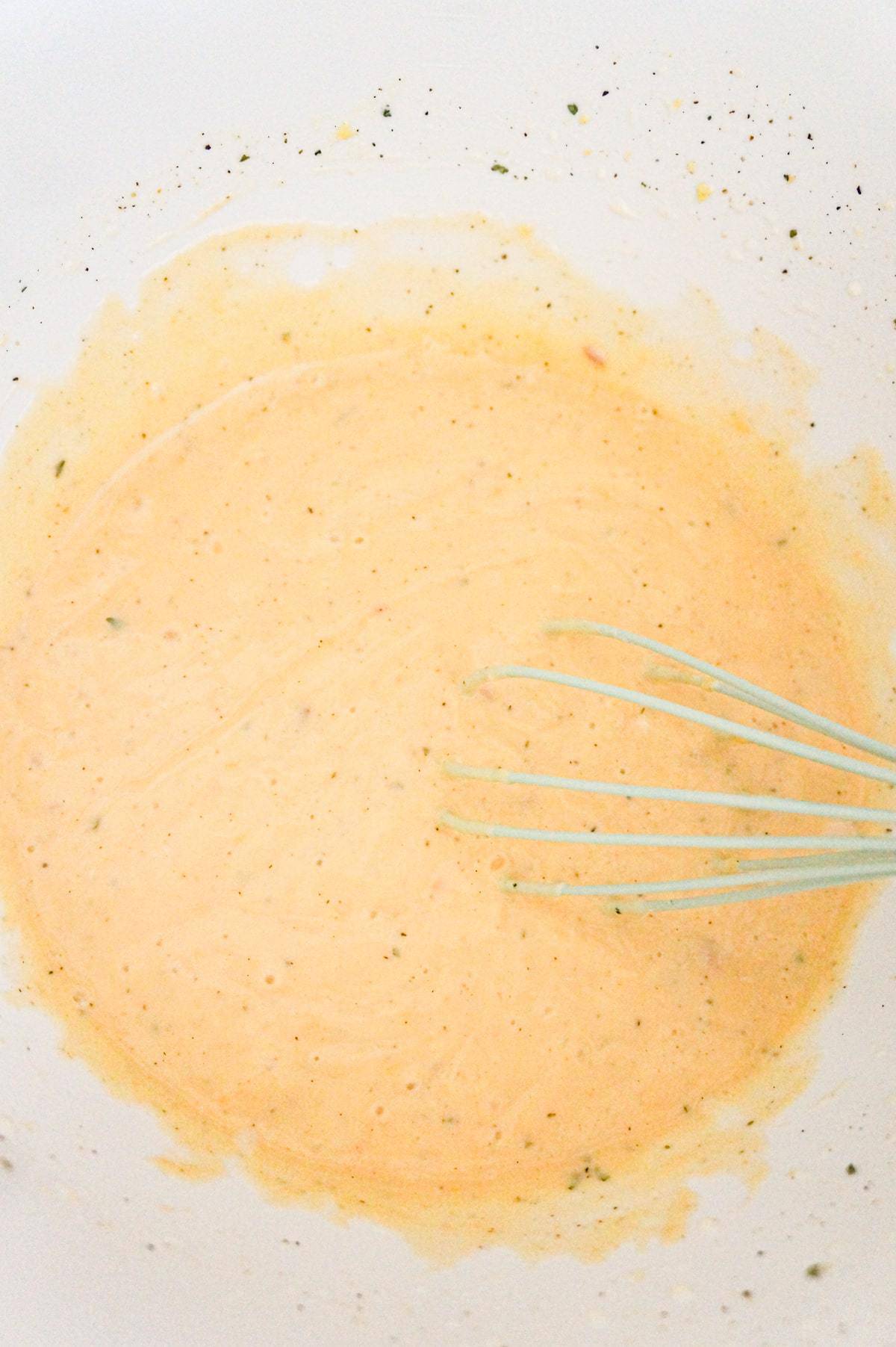 creamy cheddar and bacon soup mixture in a mixing bowl