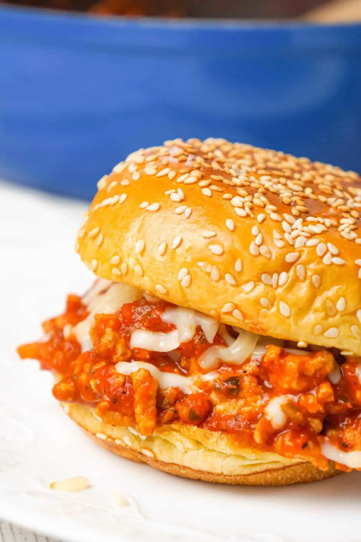 Chicken Parmesan Sloppy Joes are an easy weeknight dinner recipe made with ground chicken tossed in marinara, basil pesto and Parmesan cheese topped with shredded mozzarella and served on a toasted garlic butter brioche bun.