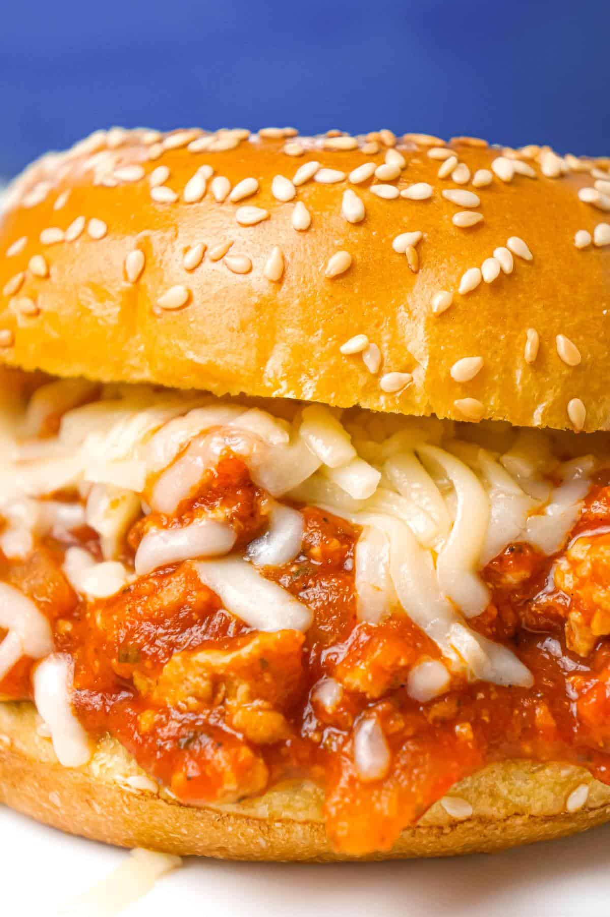 Chicken Parmesan Sloppy Joes are an easy weeknight dinner recipe made with ground chicken tossed in marinara, basil pesto and Parmesan cheese topped with shredded mozzarella and served on a toasted garlic butter brioche bun.