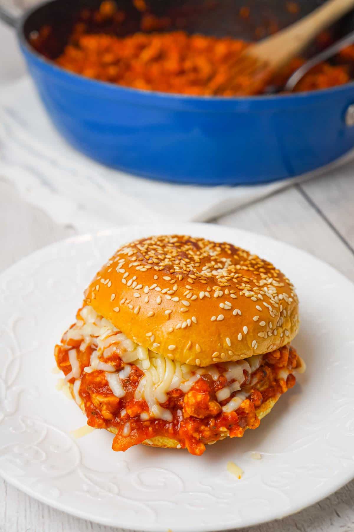 Chicken Parmesan Sloppy Joes are an easy weeknight dinner recipe made with ground chicken tossed in marinara, basil pesto and Parmesan cheese topped with shredded mozzarella and served on a toasted garlic butter brioche bun.