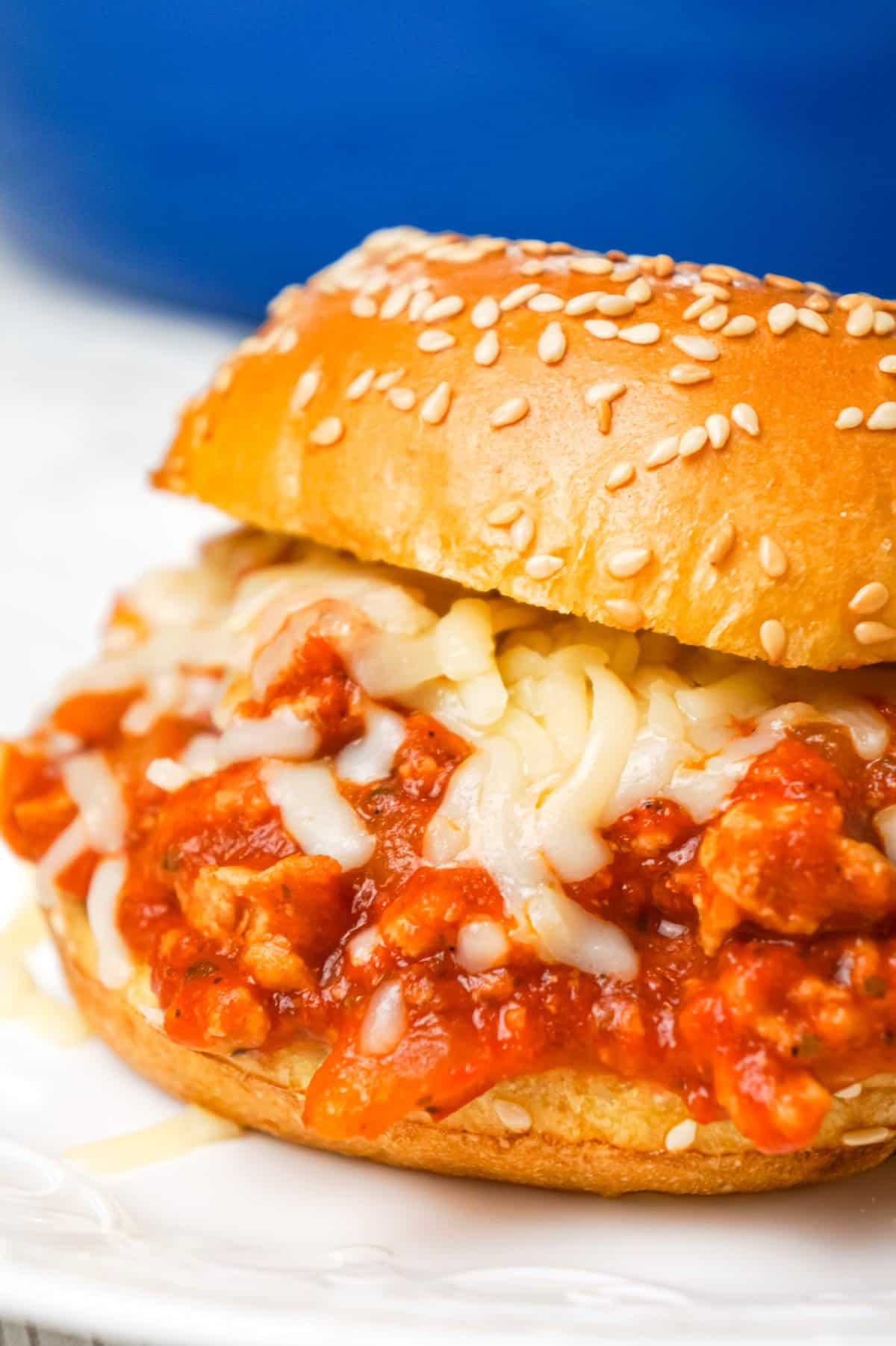 Chicken Parmesan Sloppy Joes are an easy weeknight dinner recipe made with ground chicken tossed in marinara, basil pesto and Parmesan cheese topped with shredded mozzarella and served on a toasted garlic butter brioche bun.