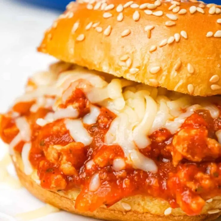 Chicken Parmesan Sloppy Joes are an easy weeknight dinner recipe made with ground chicken tossed in marinara, basil pesto and Parmesan cheese topped with shredded mozzarella and served on a toasted garlic butter brioche bun.