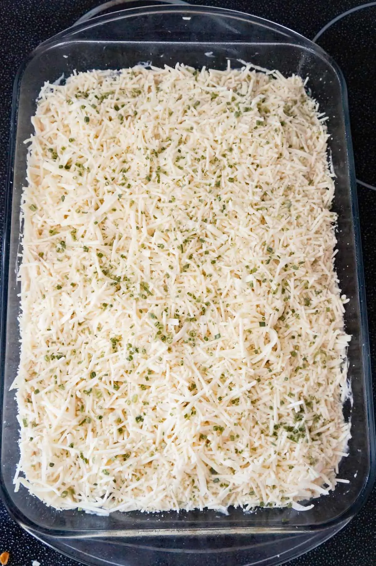 chopped chives, shredded Parmesan and shredded Mozzarella on top of chicken spaghetti before baking