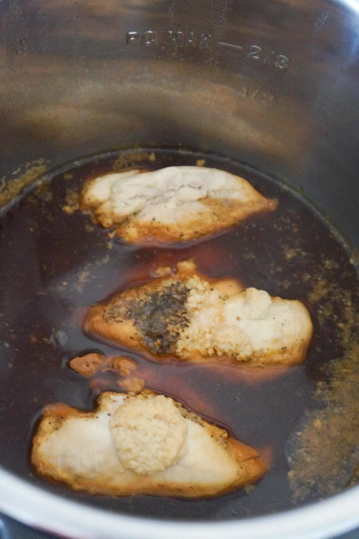 cooked chicken breasts in honey garlic sauce in an Instant Pot