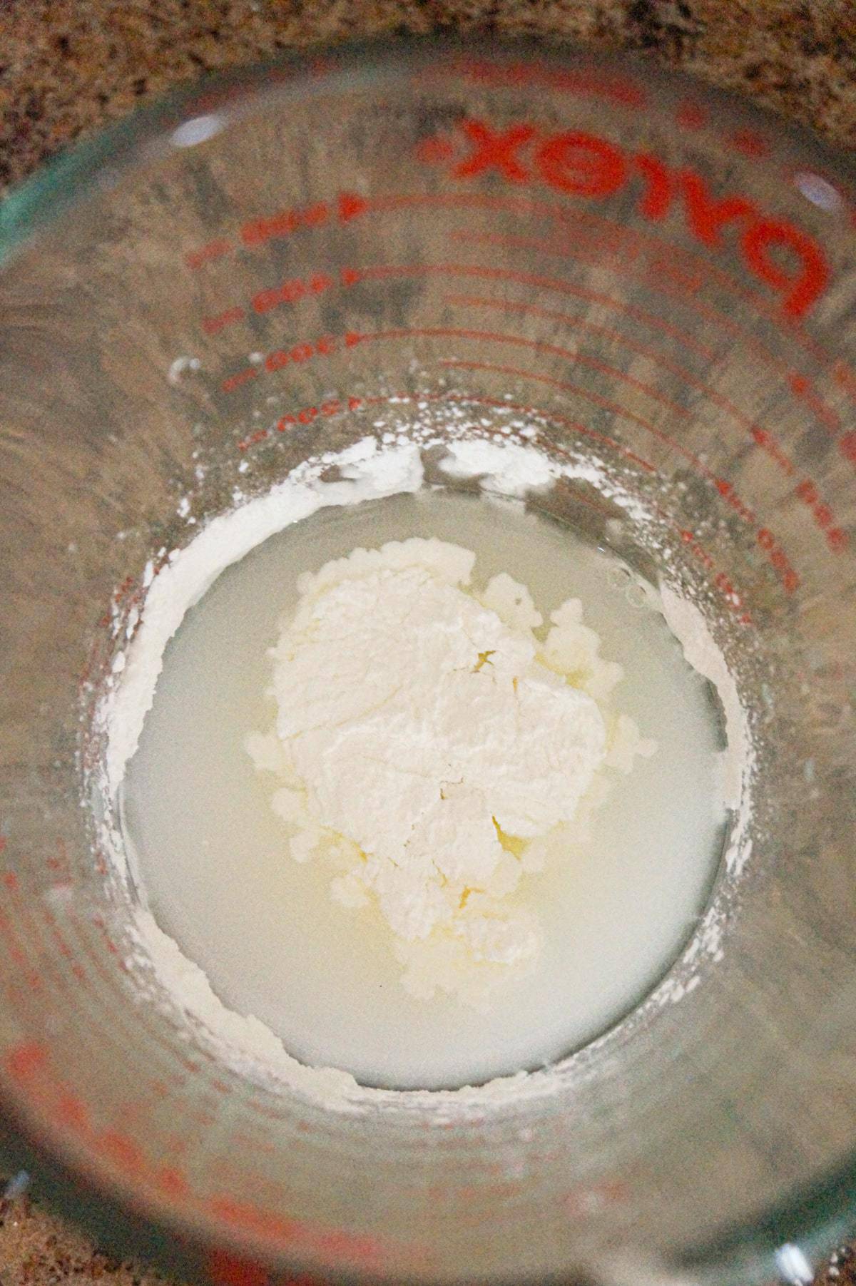 cornstarch and water in a glass measuring cup