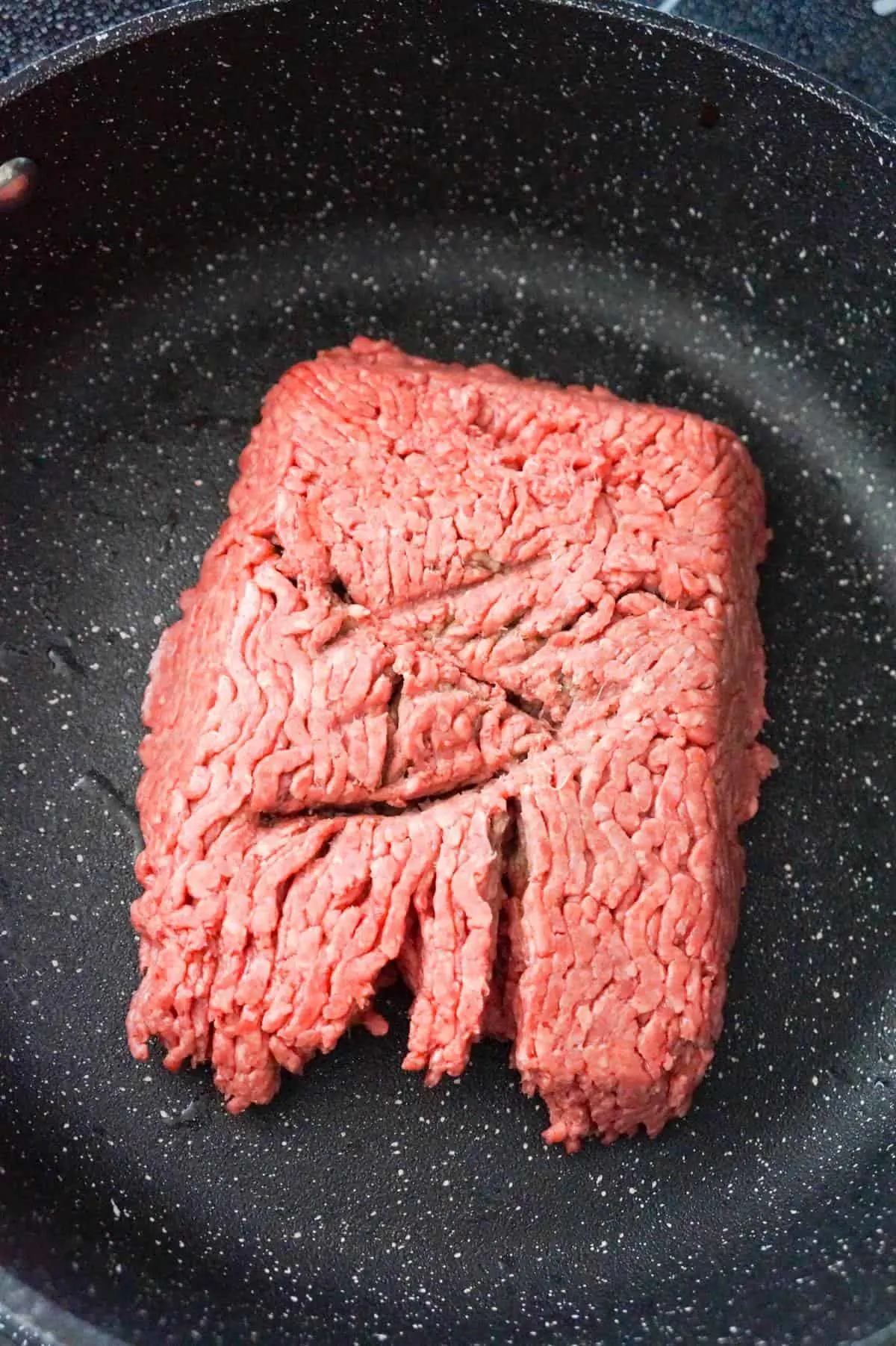 raw ground beef in a large saute pan