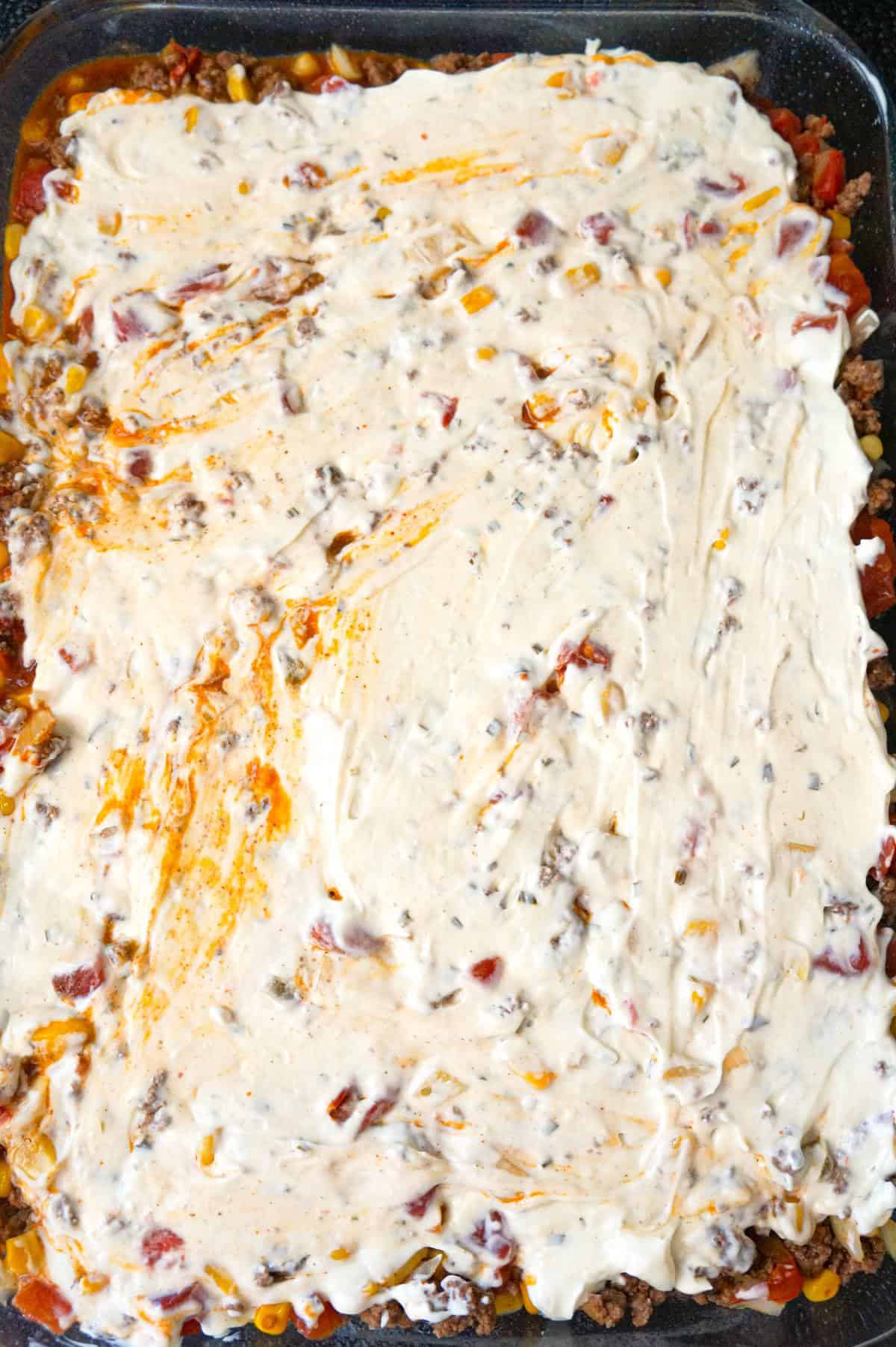 cream cheese and mayo mixture spread on top of ground beef and biscuit casserole