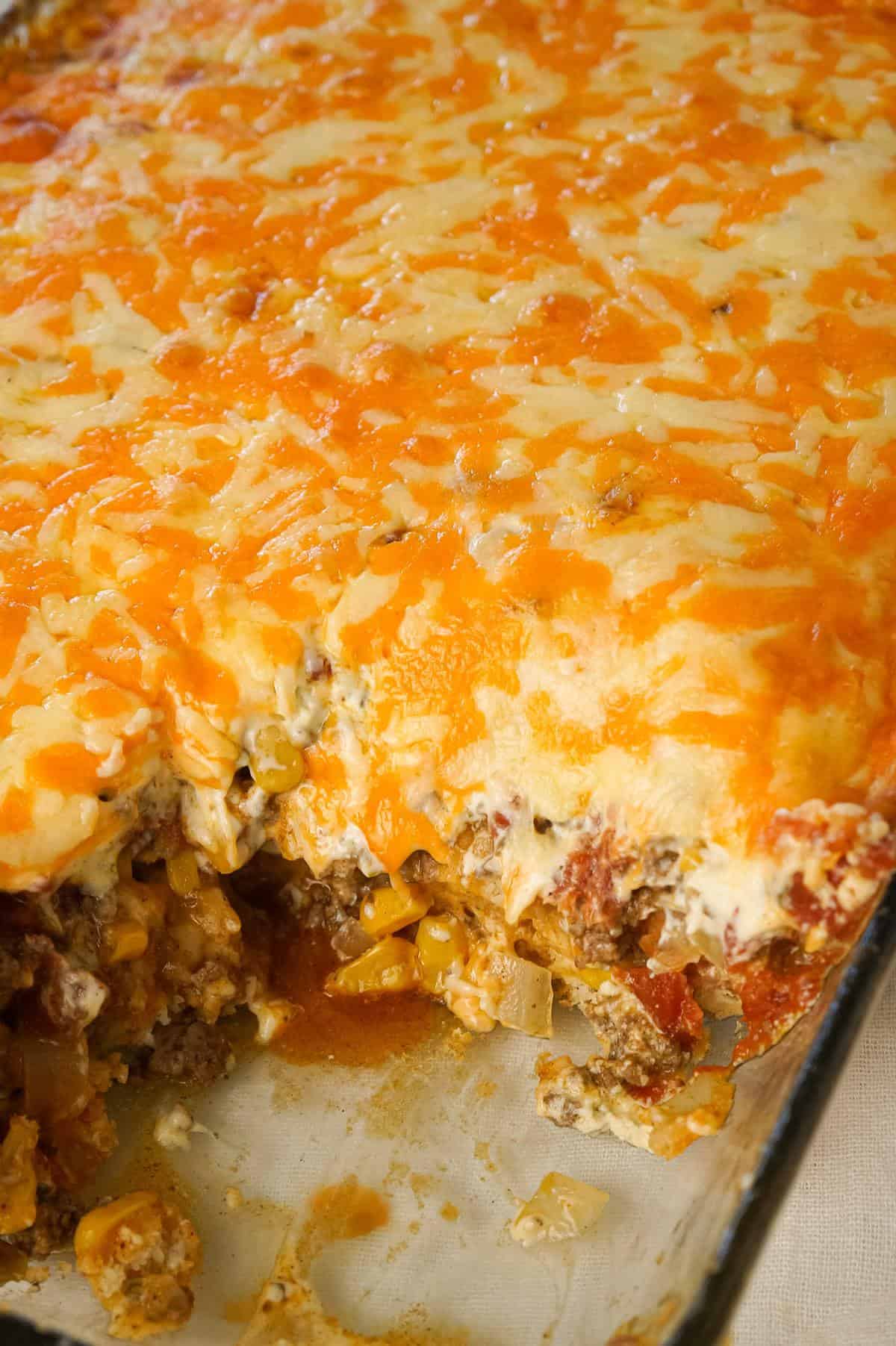 John Wayne Casserole is an easy ground beef casserole recipe with a biscuit base and loaded with diced tomatoes, corn, taco seasoning, cream cheese, mozzarella and cheddar.