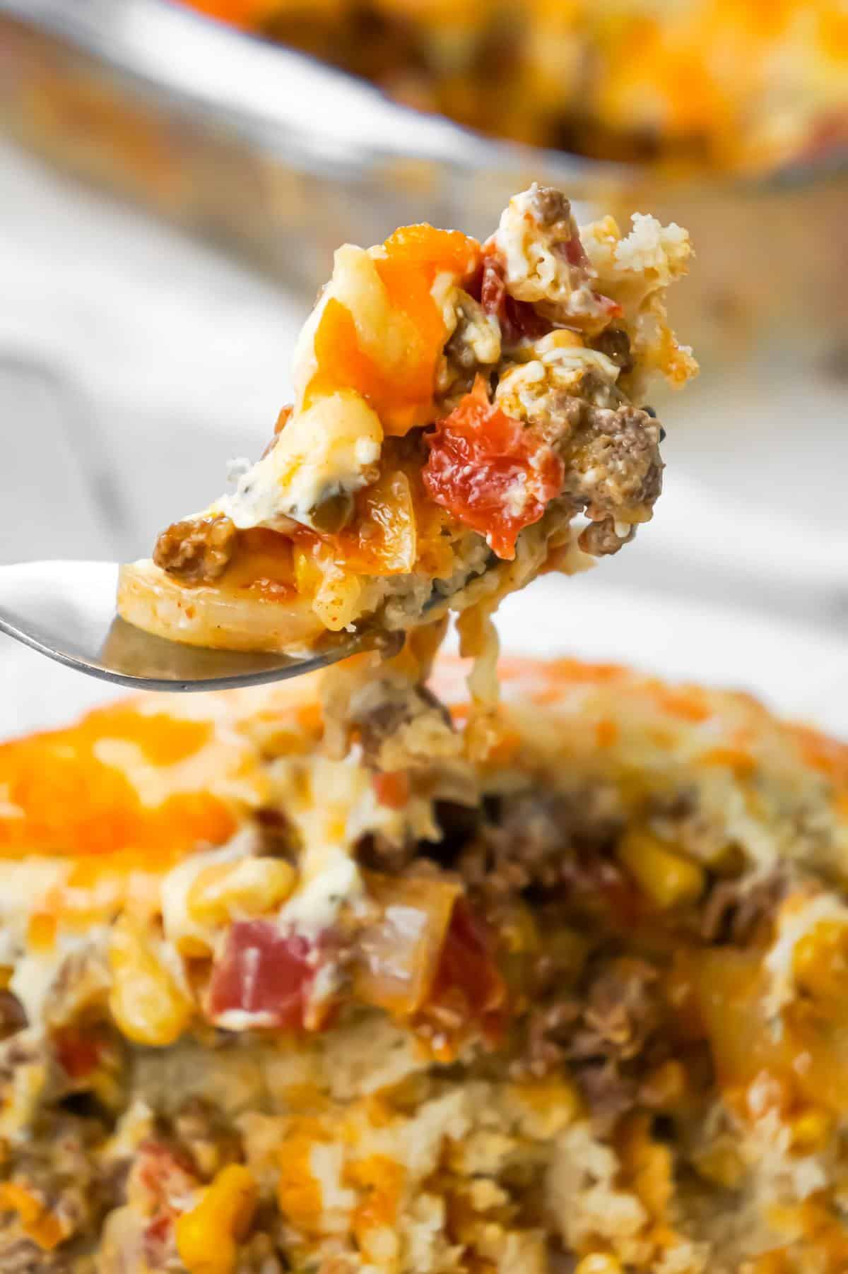 John Wayne Casserole is an easy ground beef casserole recipe with a biscuit base and loaded with diced tomatoes, corn, taco seasoning, cream cheese, mozzarella and cheddar.