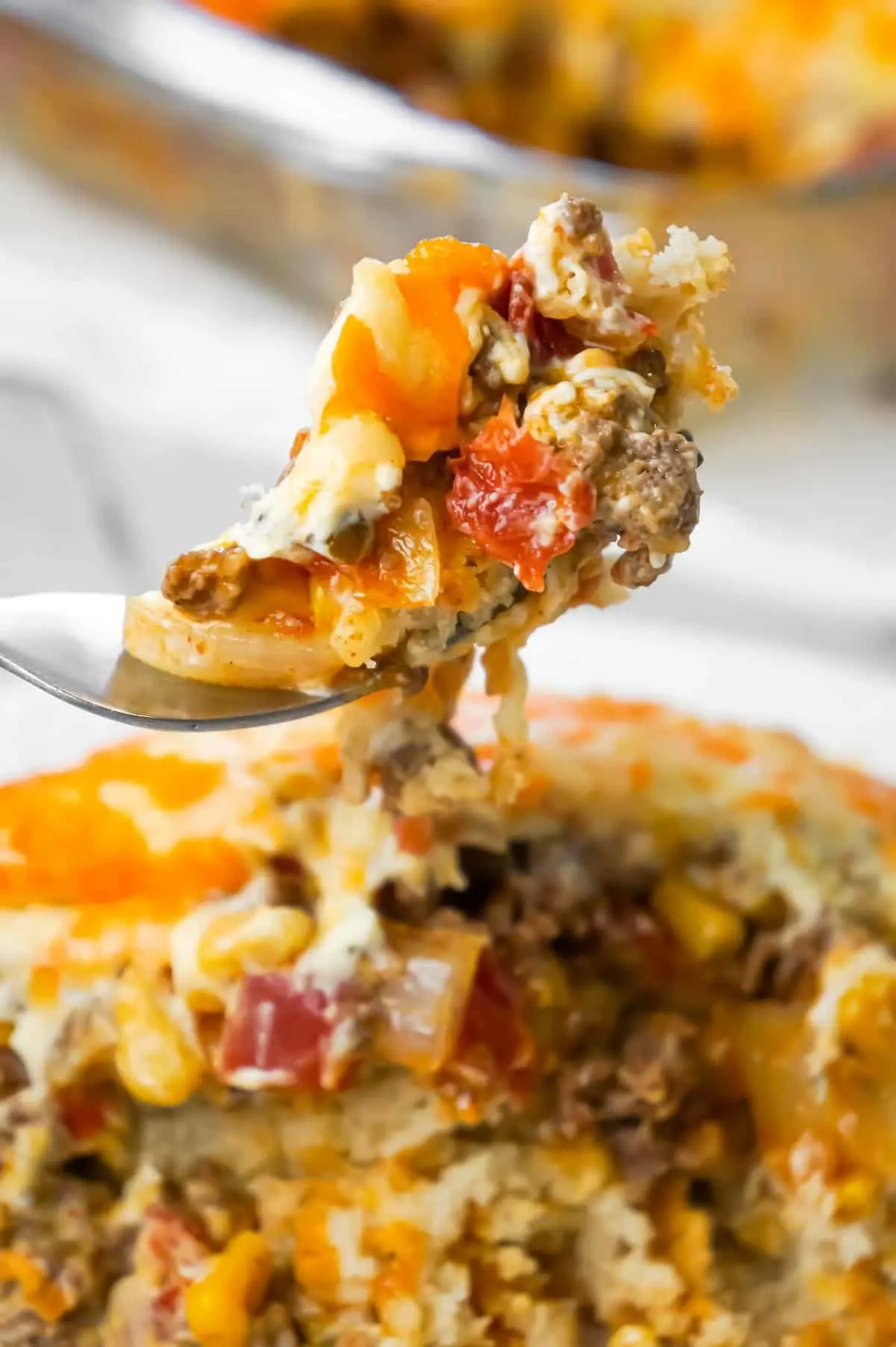 John Wayne Casserole is an easy ground beef casserole recipe with a biscuit base and loaded with diced tomatoes, corn, taco seasoning, cream cheese, mozzarella and cheddar.