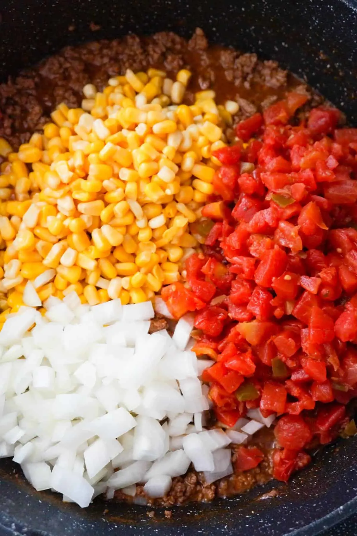 diced onions, Rotel, corn and ground beef in a large saute pan