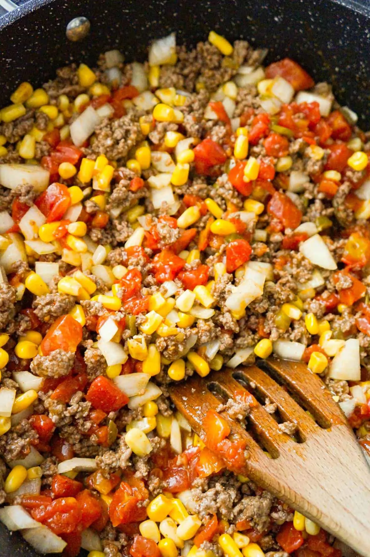 diced tomatoes, diced onions, corn and ground beef in a large saute pan