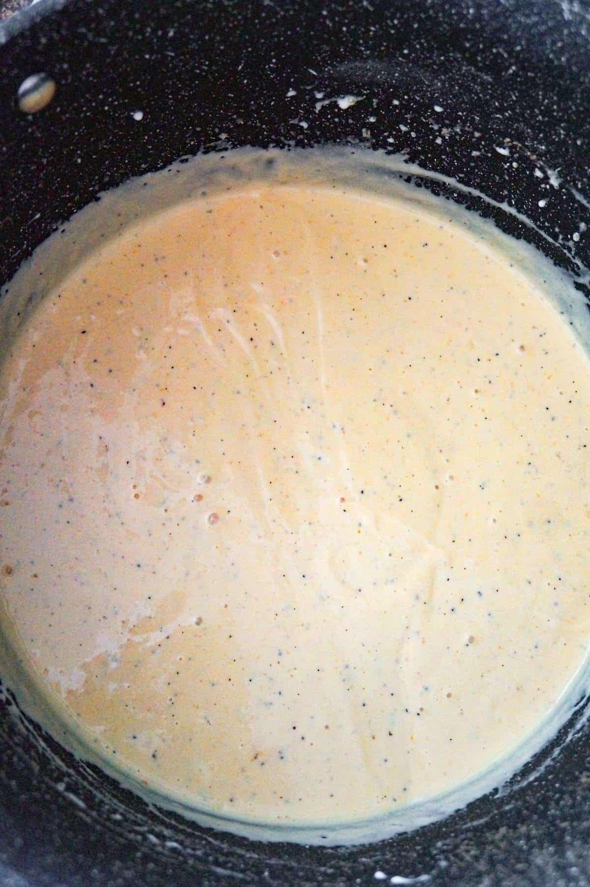 cheddar soup and heavy cream mixture in a large pot