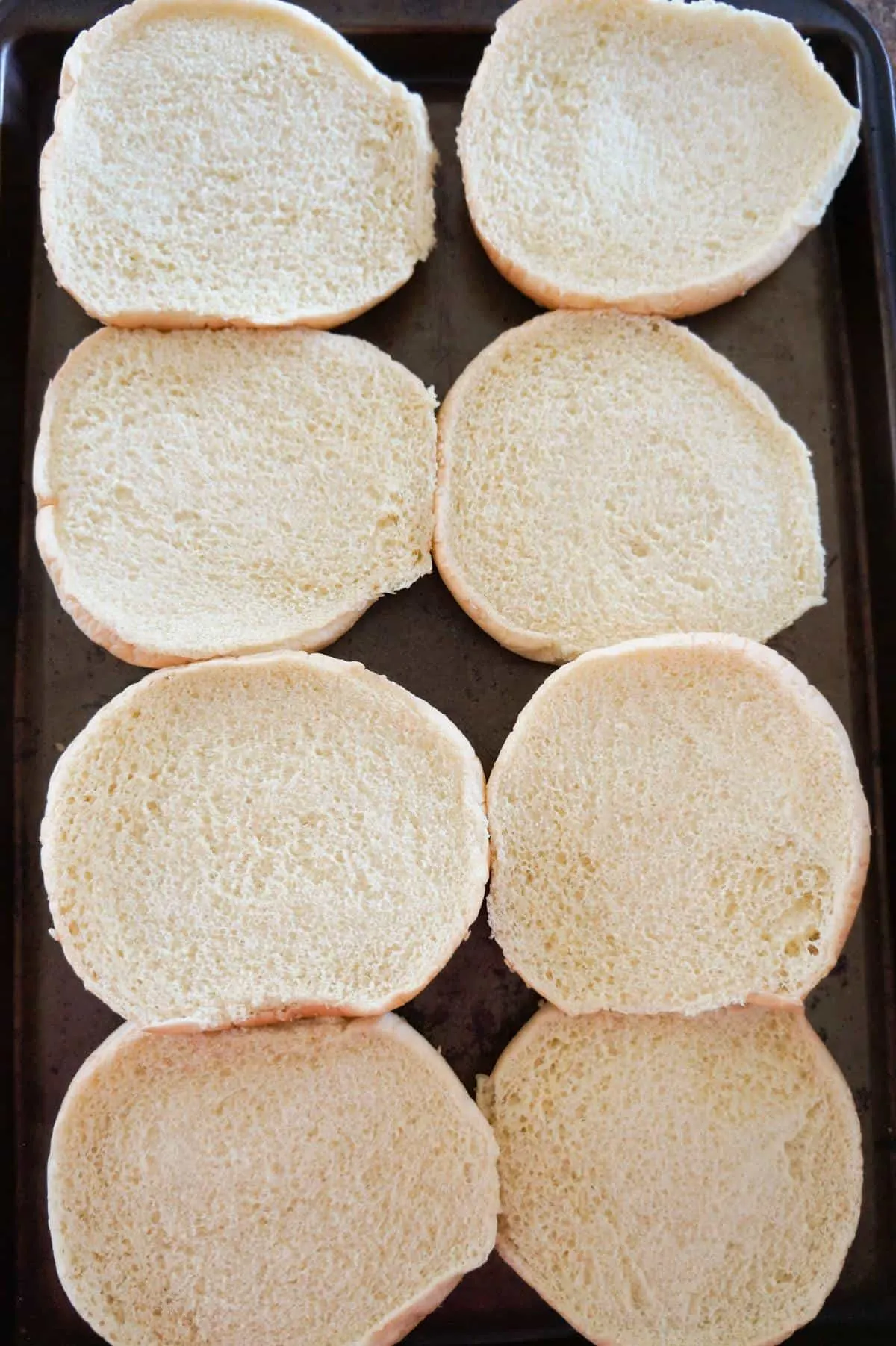 hamburger buns on a baking sheet