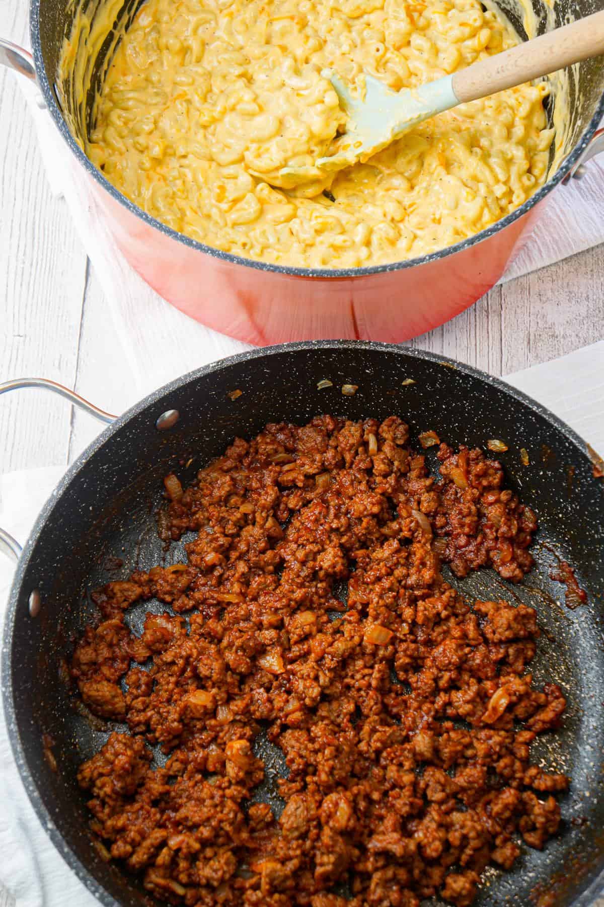 Mac and Cheese Sloppy Joes are hearty ground beef sandwiches topped with macaroni and cheese.