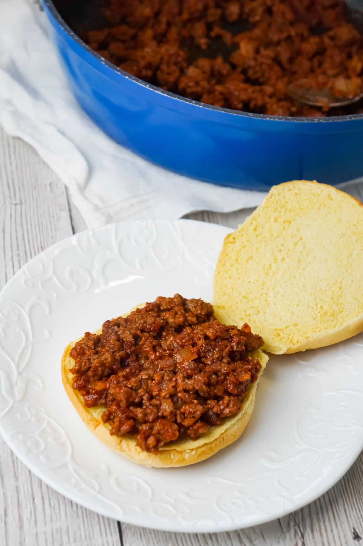 Mac and Cheese Sloppy Joes are hearty ground beef sandwiches topped with macaroni and cheese.