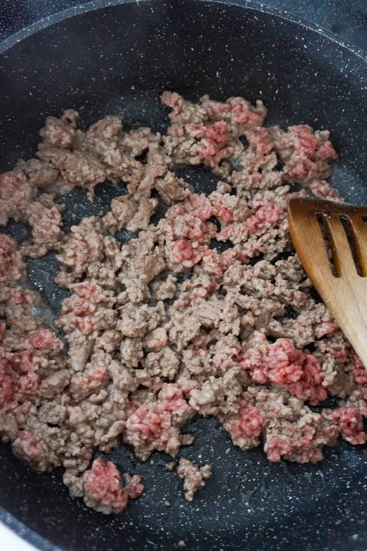 ground beef cooking in a saute pan