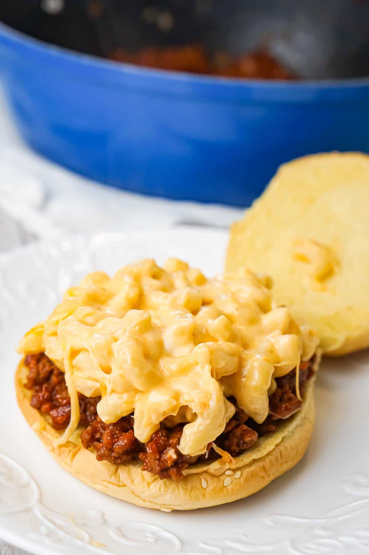 Mac and Cheese Sloppy Joes are hearty ground beef sandwiches topped with macaroni and cheese.