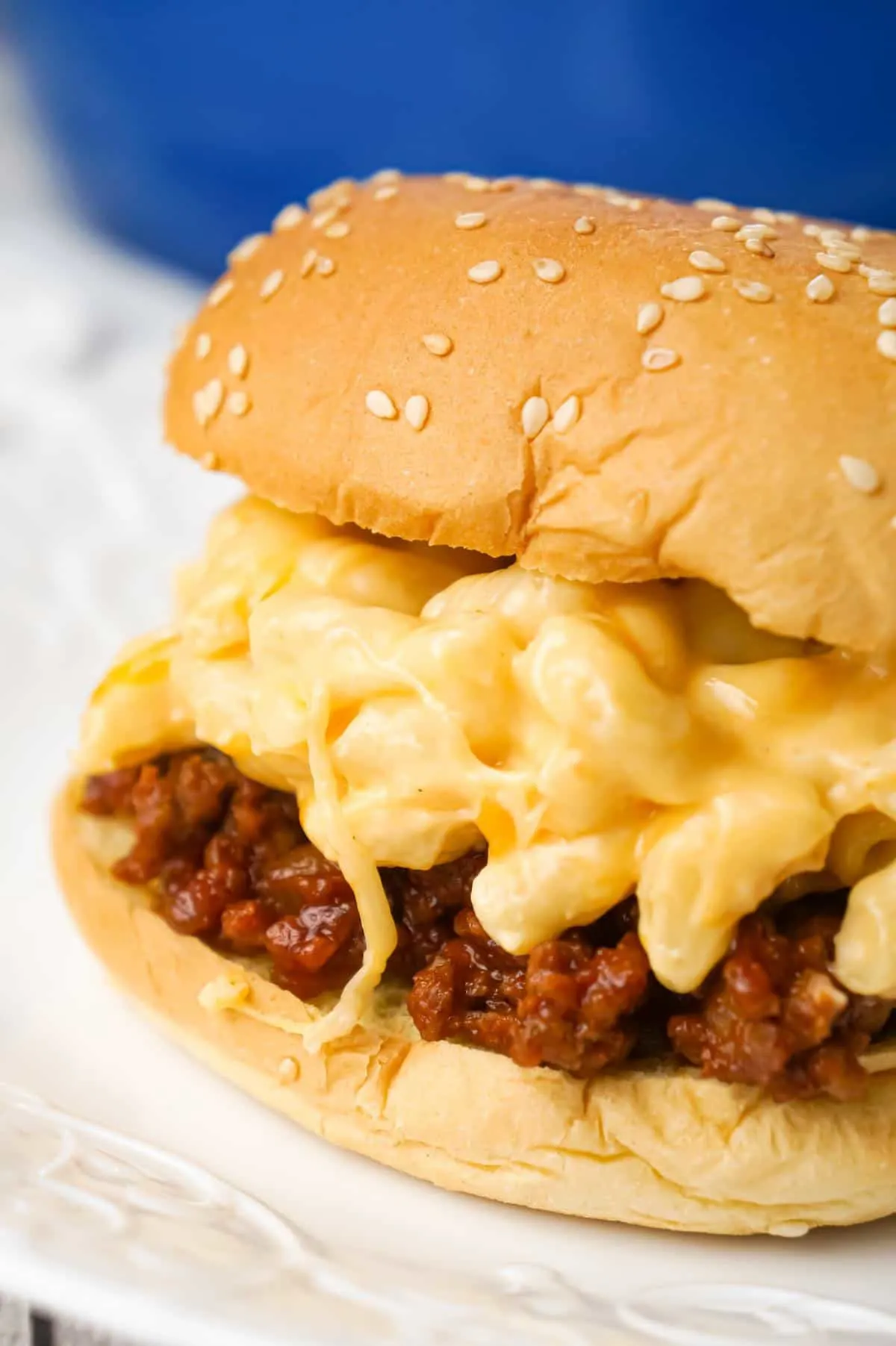 Mac and Cheese Sloppy Joes are hearty ground beef sandwiches topped with macaroni and cheese.